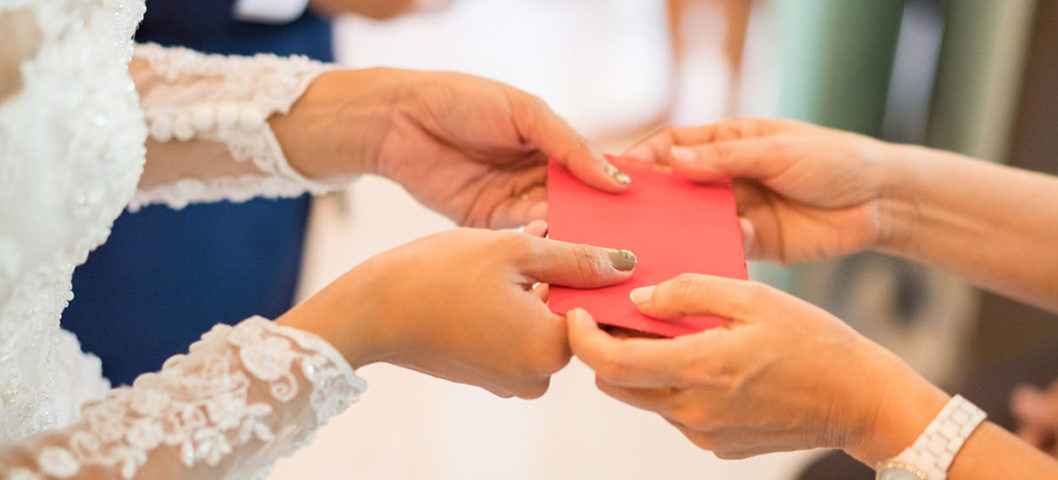 Woman-displaying-proper-wedding-etiquette-by-exchanging-gift-with-bride