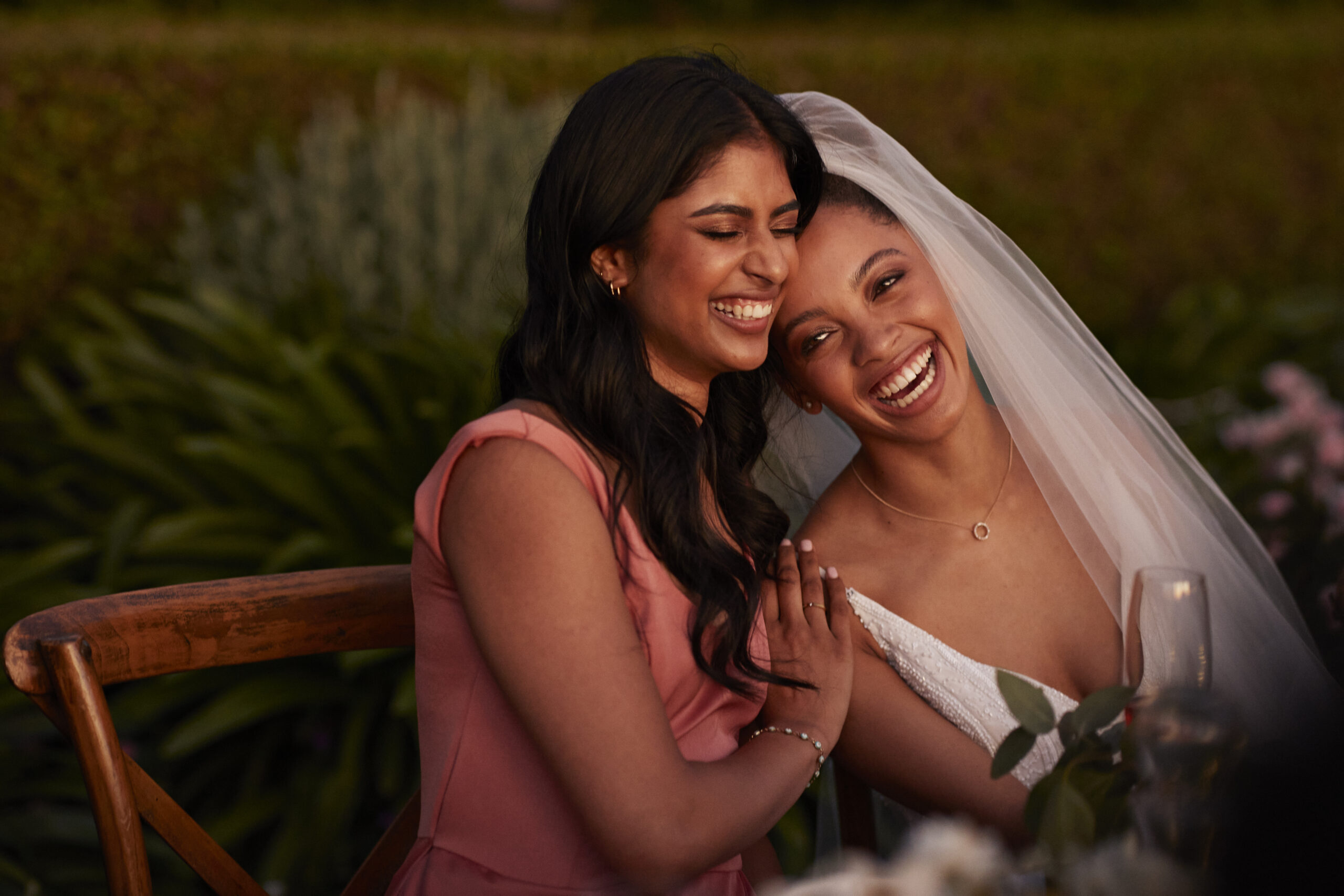 bride and bridesmaid sitting at a table