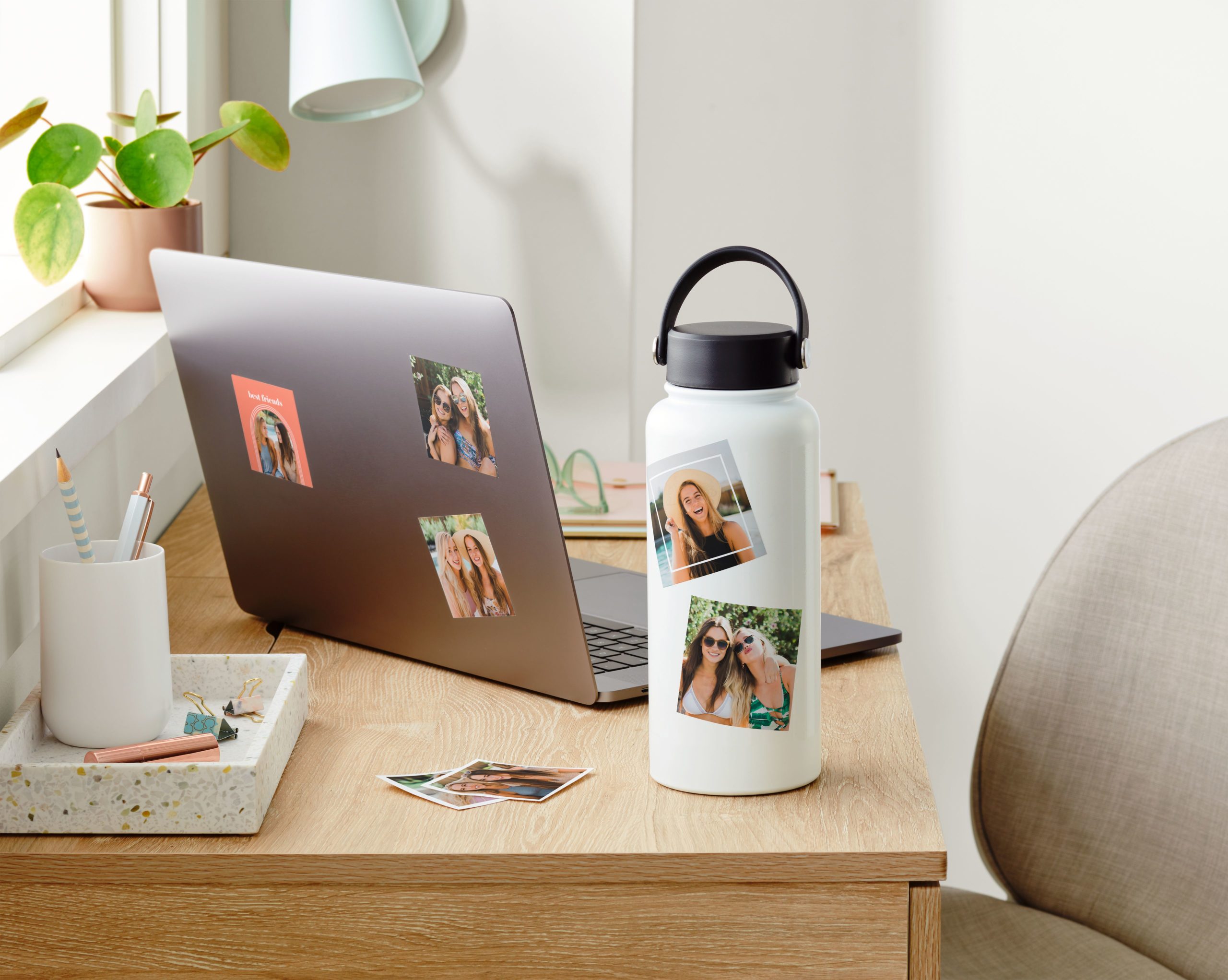 custom stickers on a water bottle and laptop