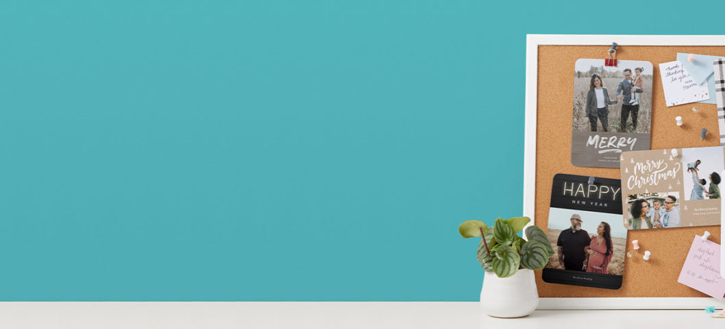 hero custom greeting cards with cards posted on a cork board on a desk