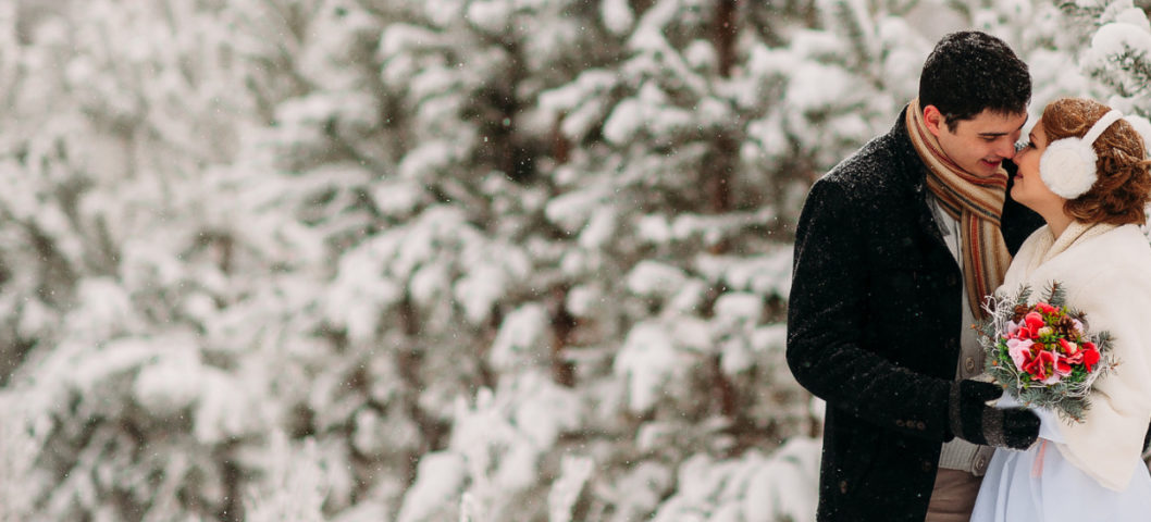 A couple celebrating their winter wedding in the snow