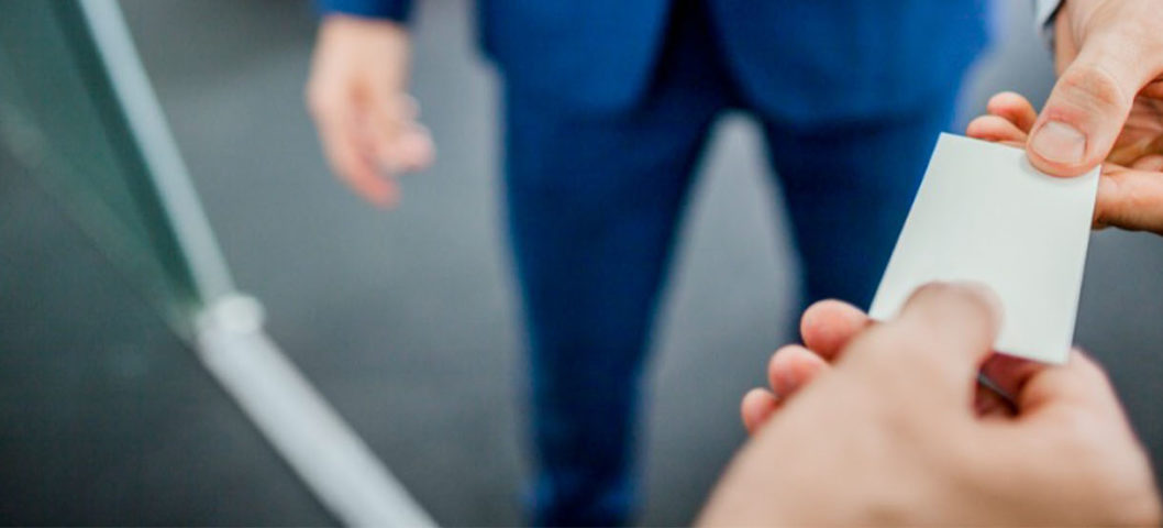 Business card exchange with two people in an office setting
