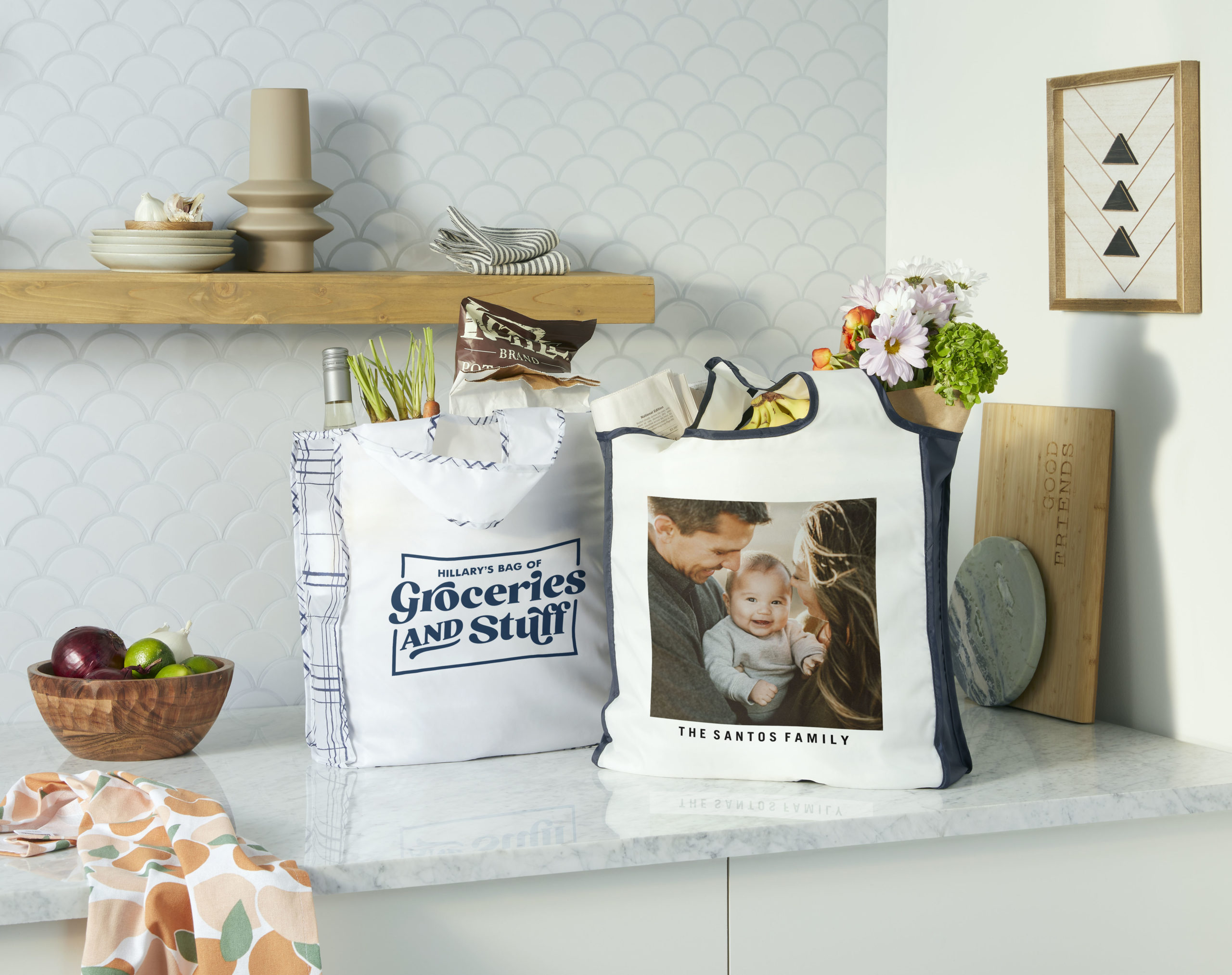 Kitchen countertop filled with reusable grocery bags wooden cutting boards and kitchen decor displayed on the walls