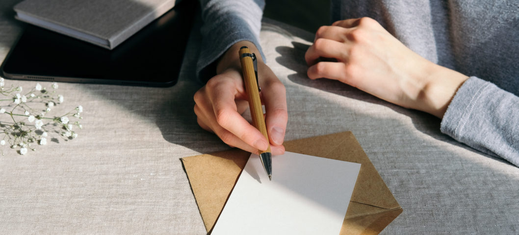 Woman-writing-out-a-wedding-card-for-her-friend-getting-married