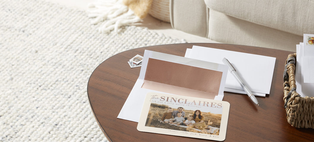 Personalized holiday greeting cards featuring custom envelopes with stamps