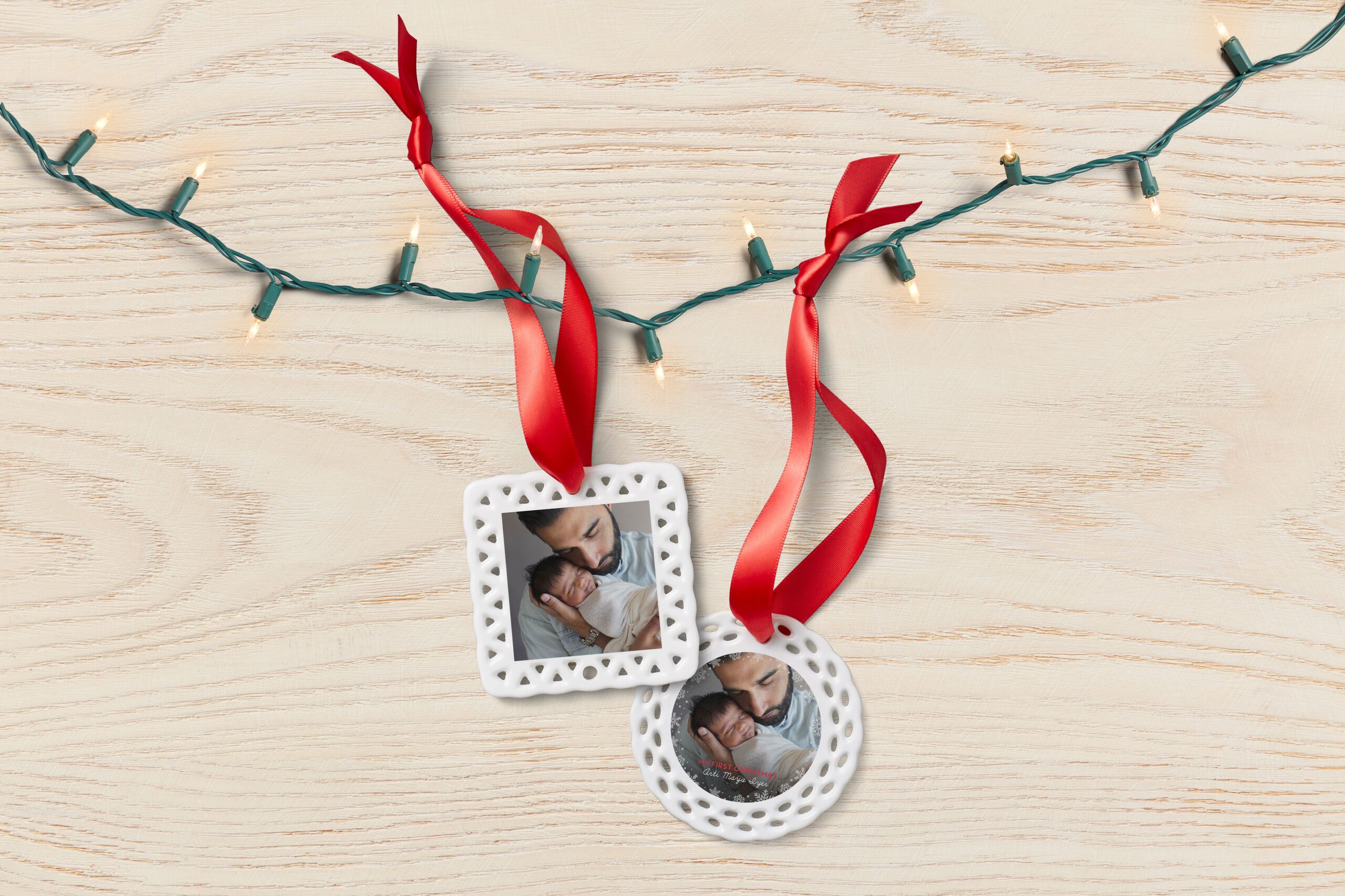 two personalized christmas ornaments with photos of a father and baby
