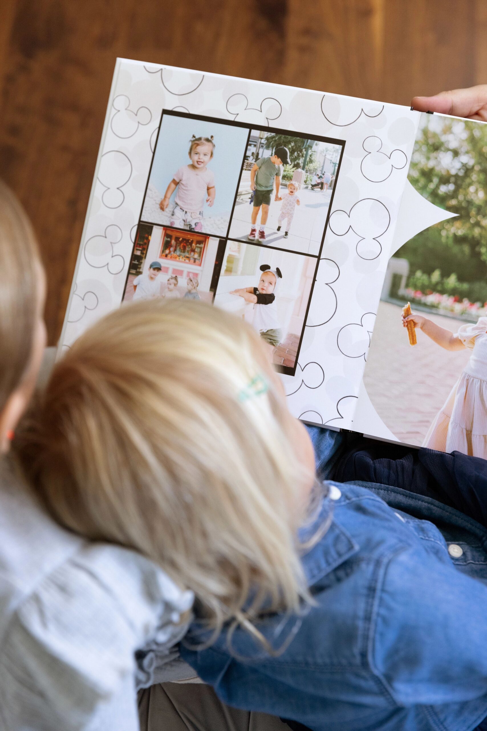 little girl flipping through disney photo book