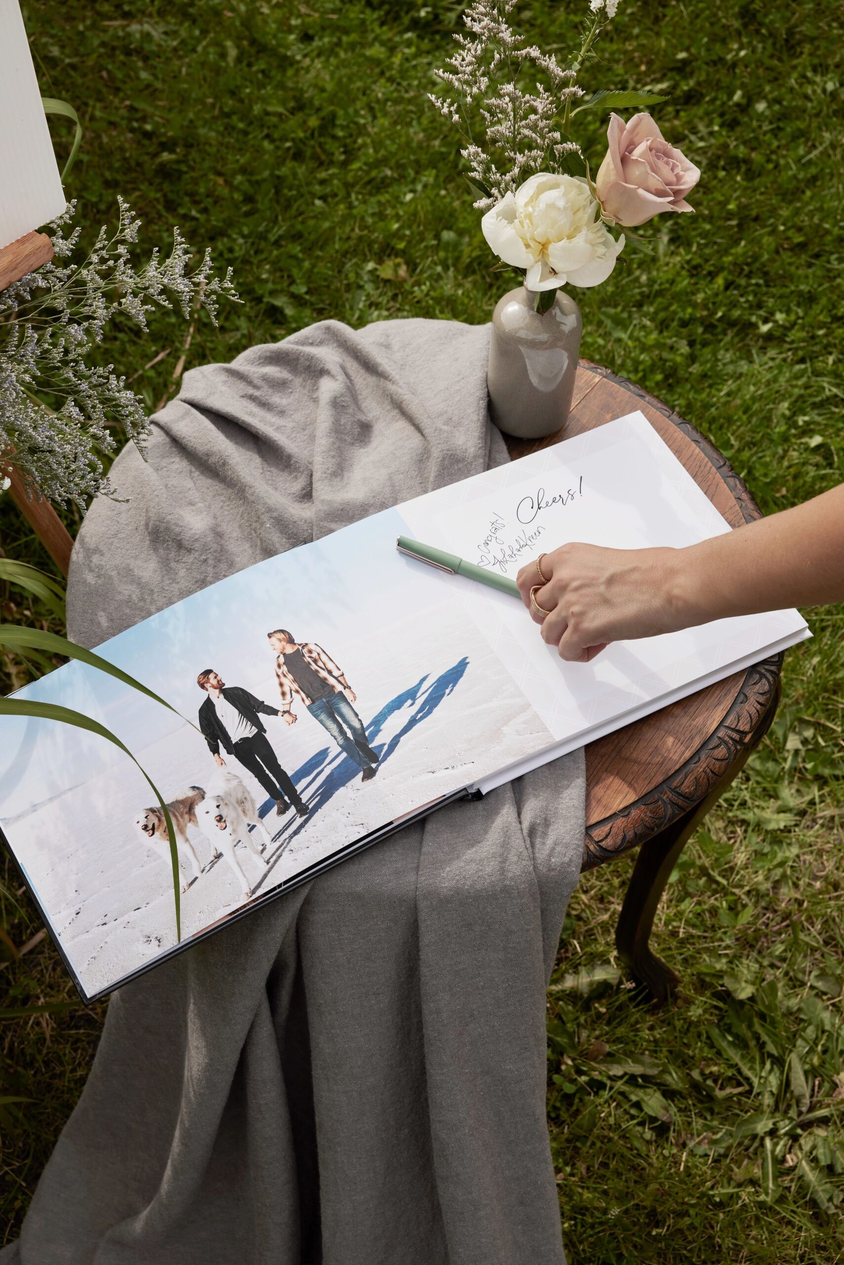 open wedding guest book with guest signing the page